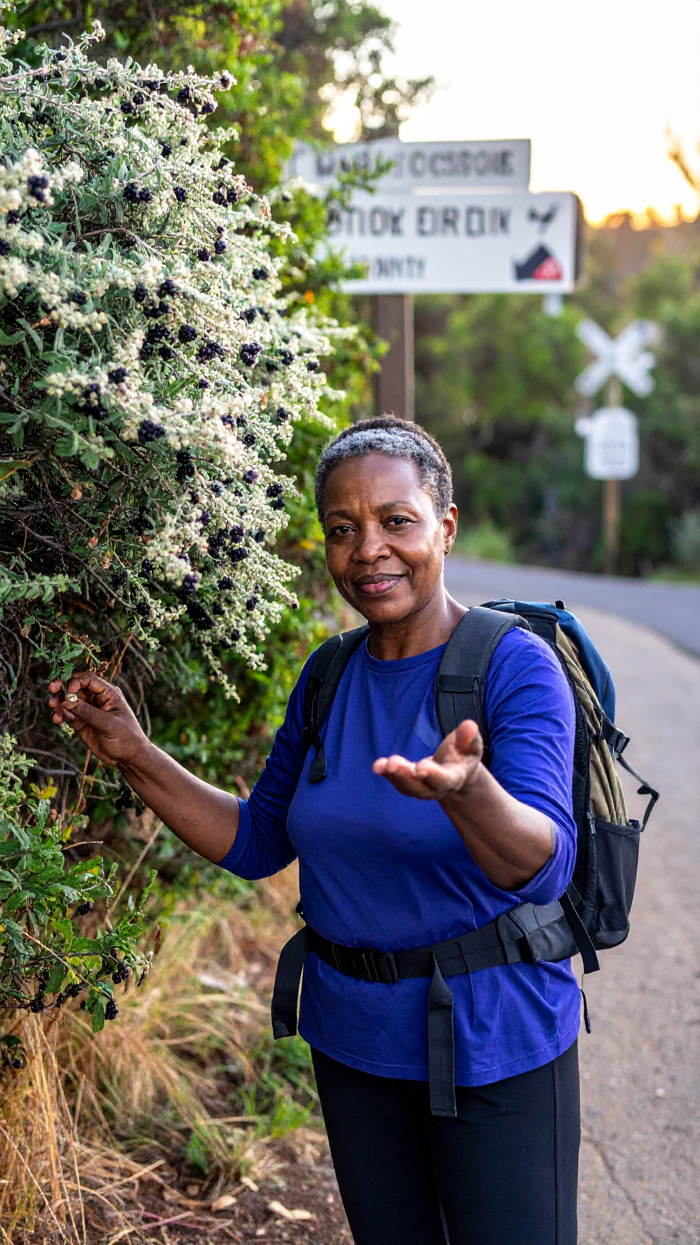 A woman on a hiking trail inviting you to join.